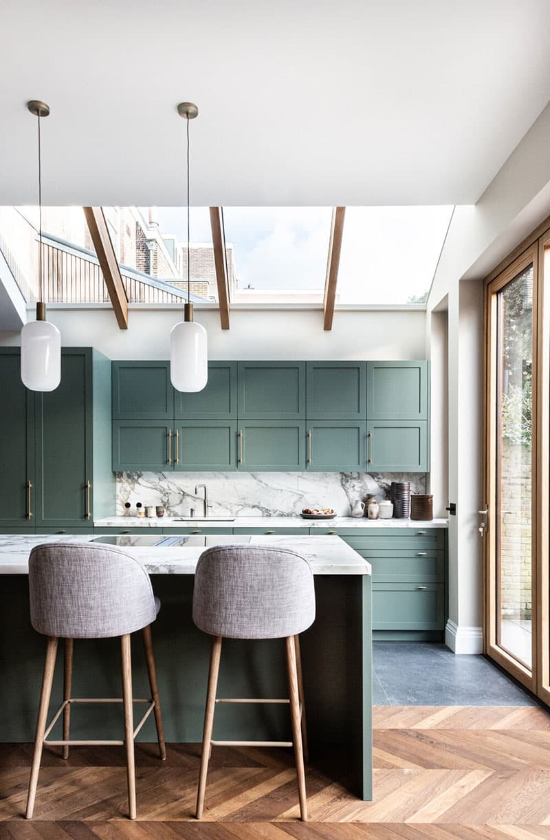 this is a mid century modern kitchen with olive green