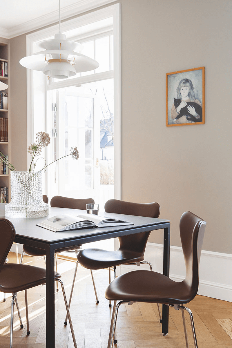 this is a Scandinavian dining room showcasing a gallery wall, a classic Scandinavian interior addition