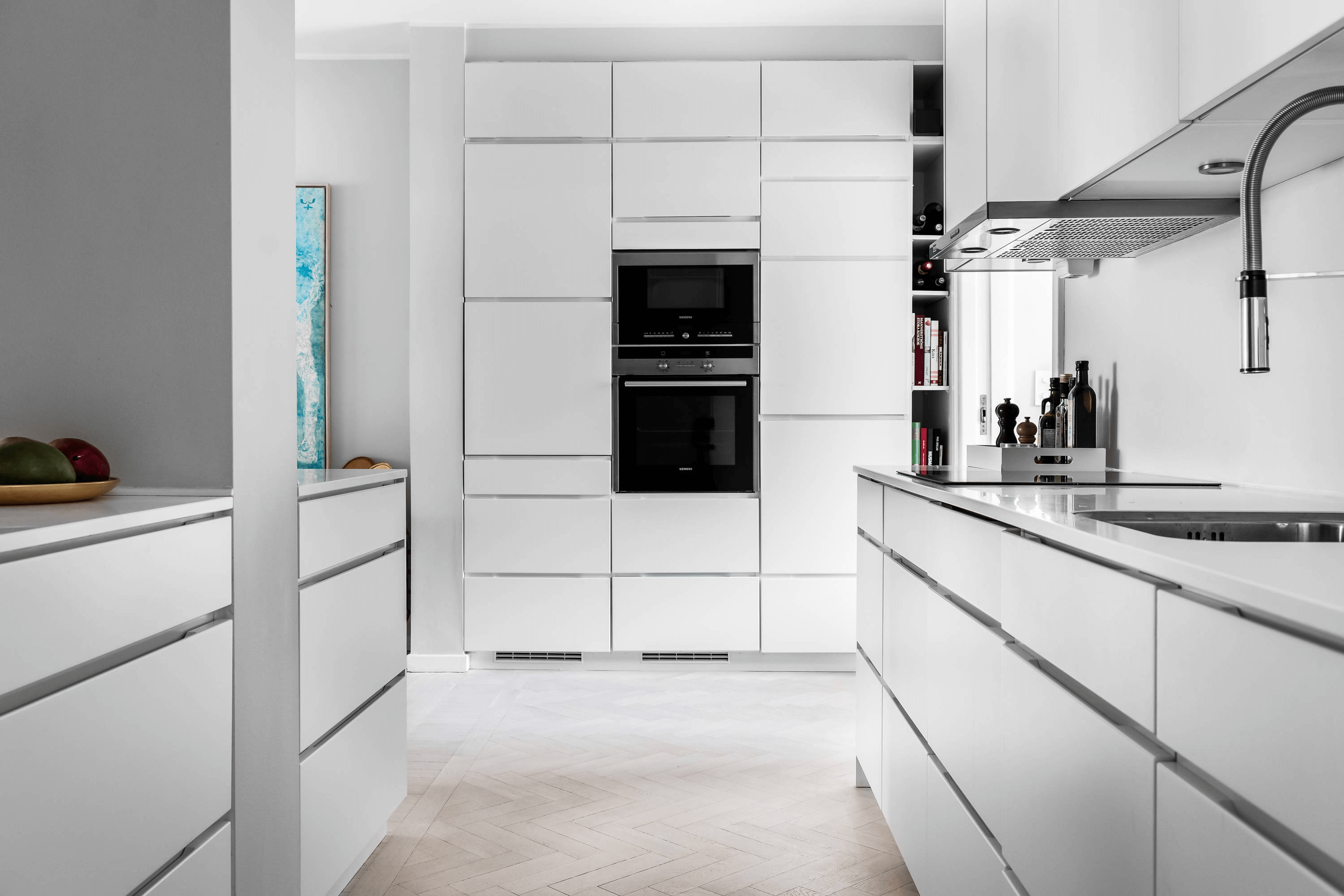 this is a modern scandinavian kitchen with white fixtures, clean lines and minimal objects on surfaces