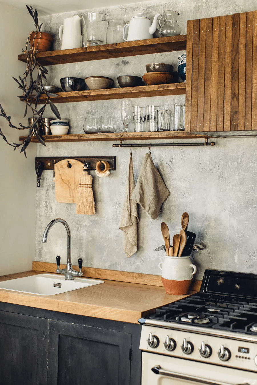 this is a rustic look Scandinavian kitchen with wooden shelves and a arga oven(1)