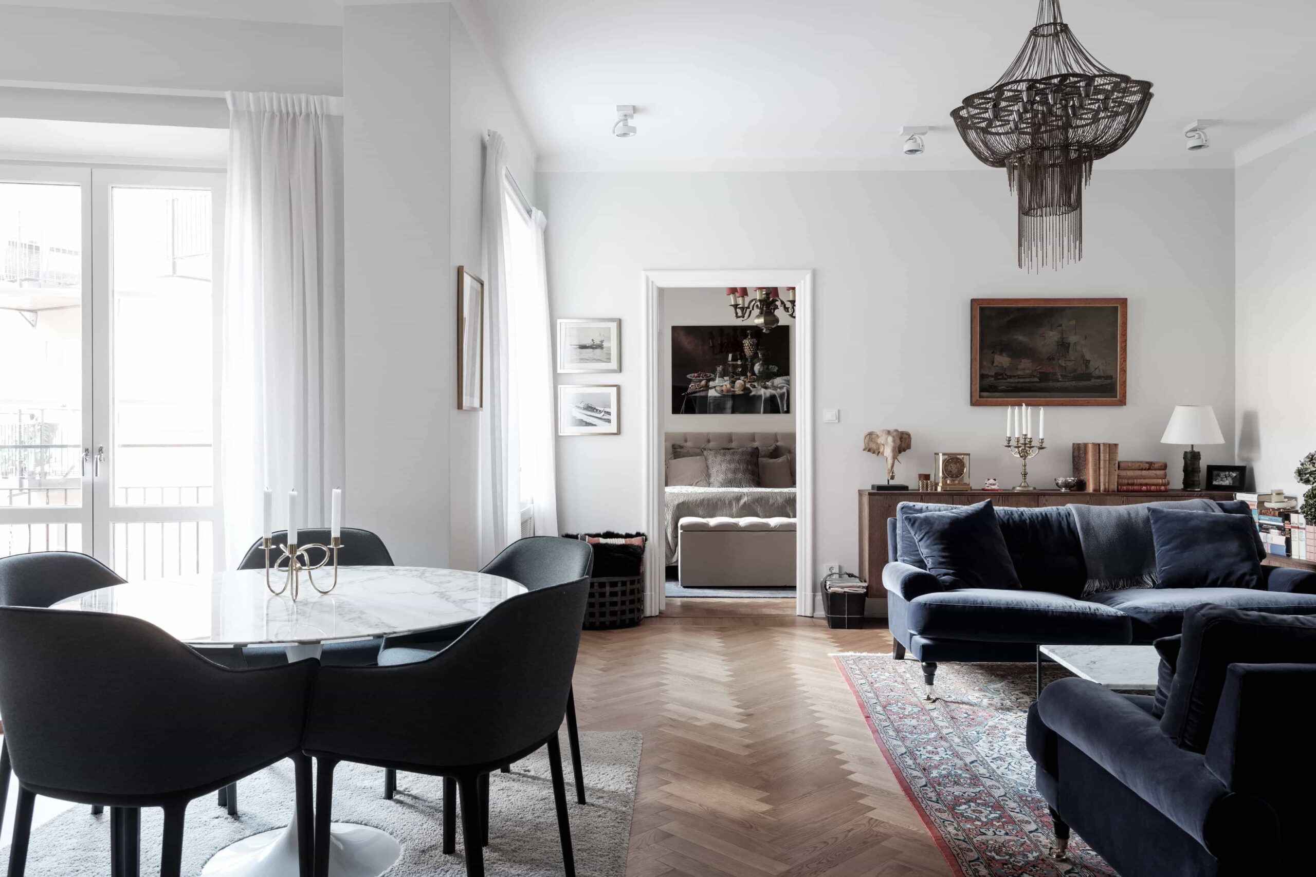 this is a scandinavian apartment with blue velvet dining chairs and vintage elements