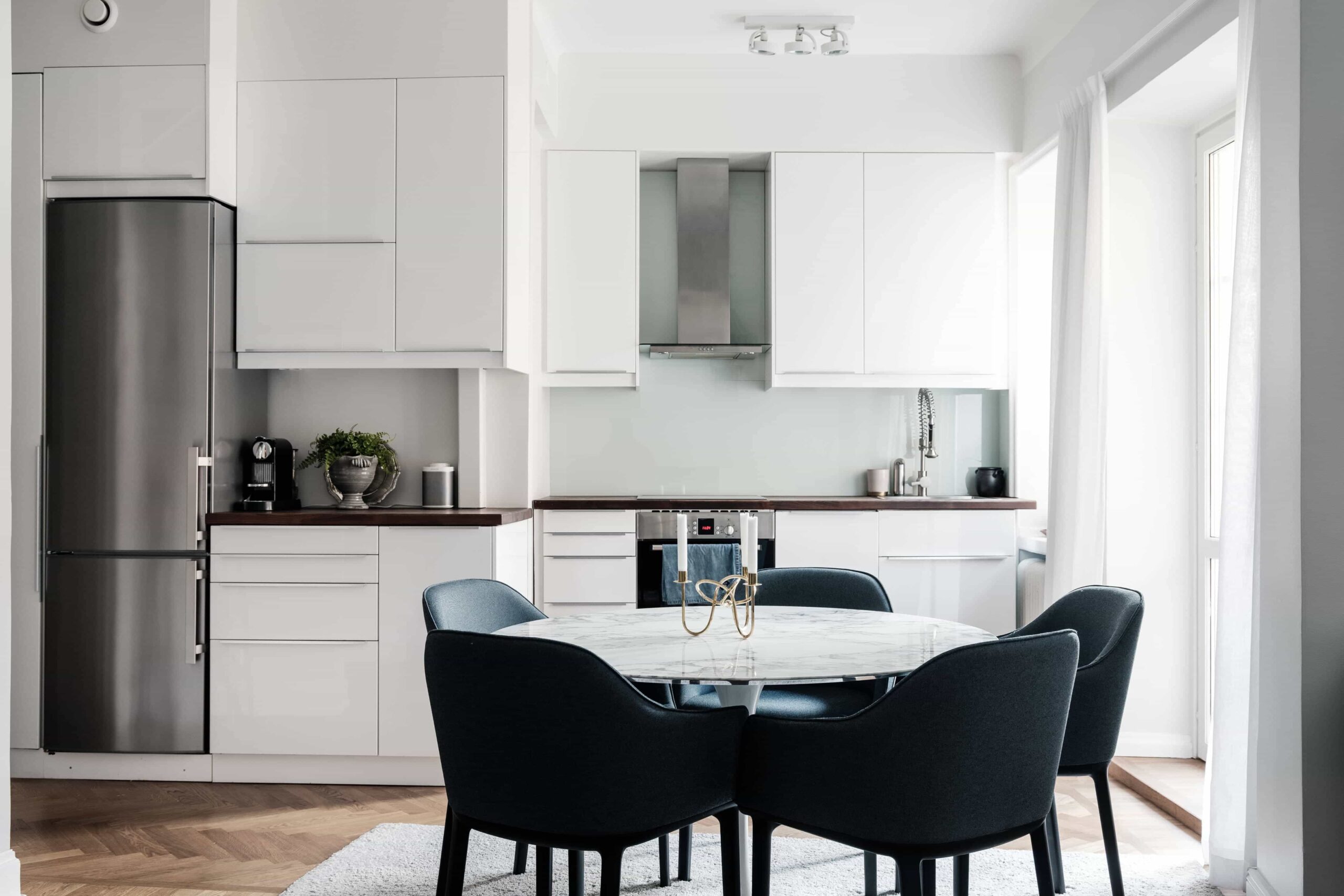 this is a scandinavian kitchen with velvet vintage chairs