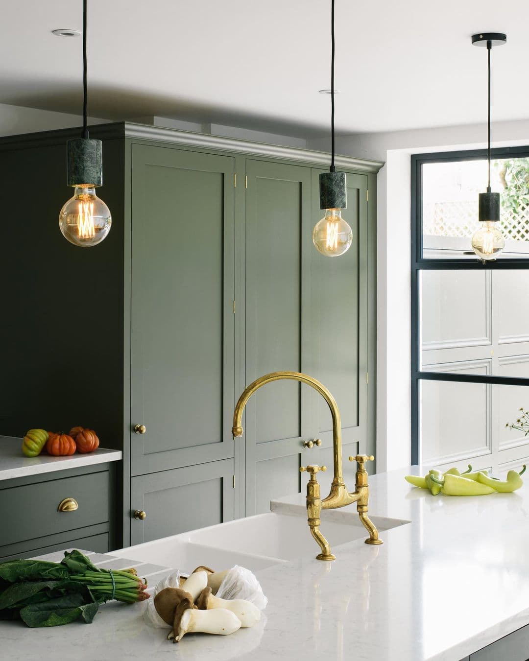 this is a deVOL kitchen with a two sink butler sink and gold taps