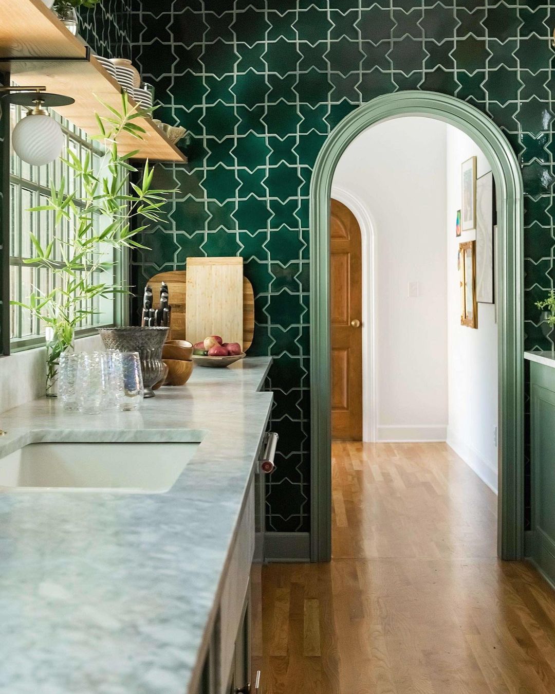 this is a kitchen with green tiles by Rebecca Gibbs