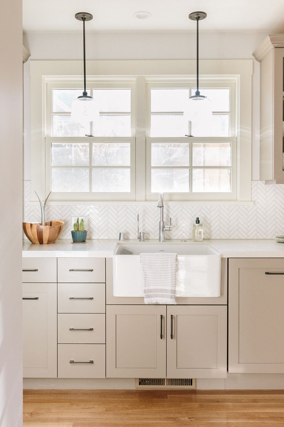 this is a white porcelain Belfast sink featured in a kitchen designed by nina jizhar