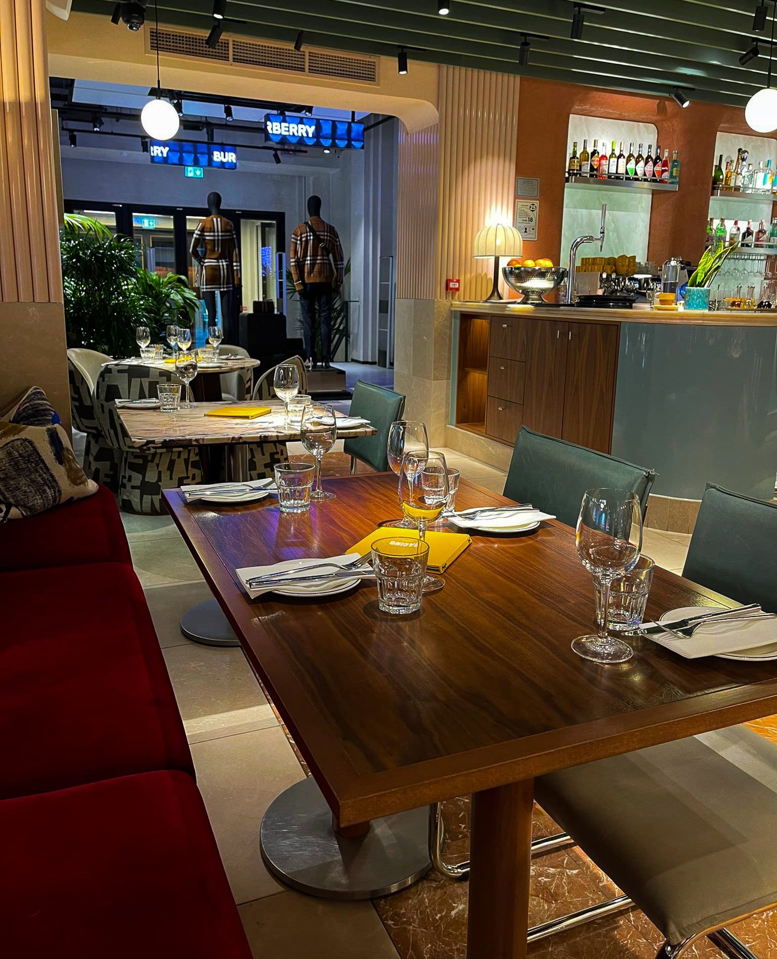 this is a look inside Bacino, Liverpool showing the larger dining tables and red velvet sofa